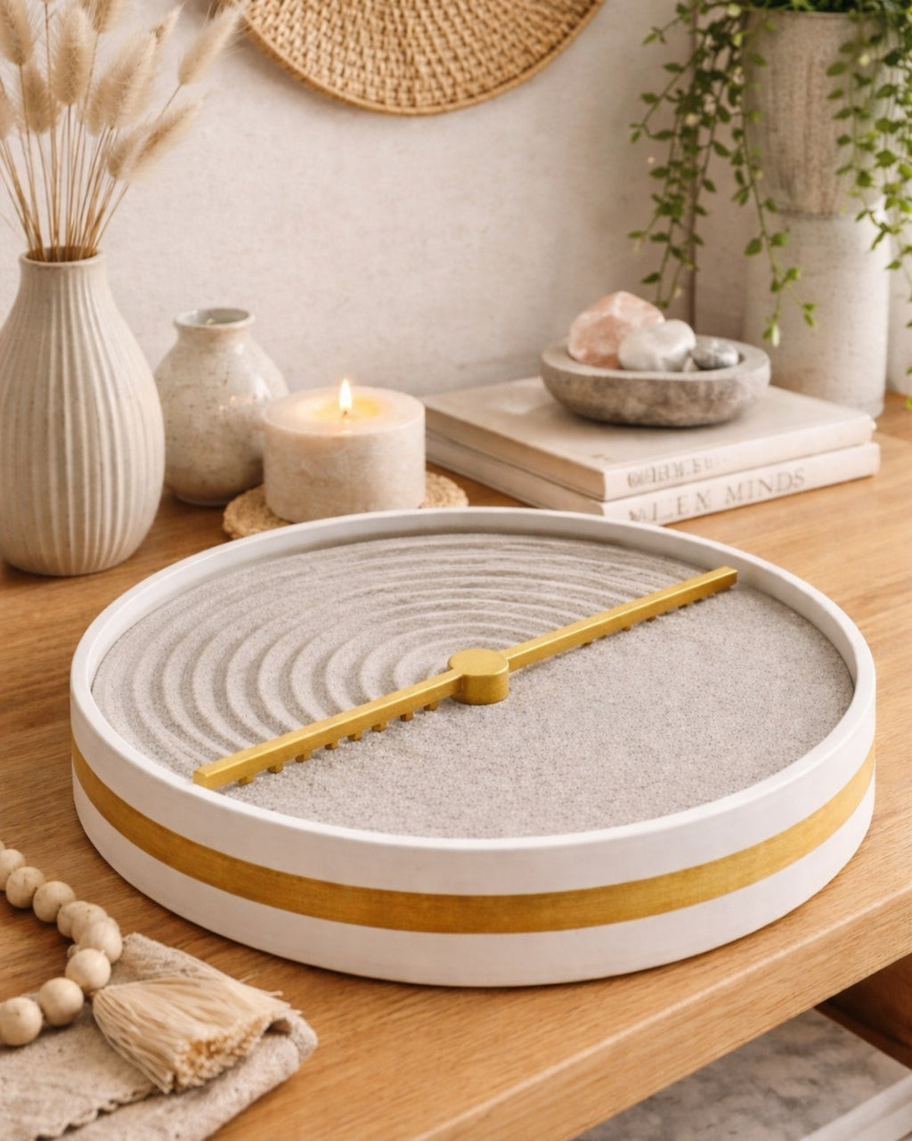 Decorative Zen sand tray featuring a moving golden arm that creates calming circular patterns in textured sand for mindful home décor.